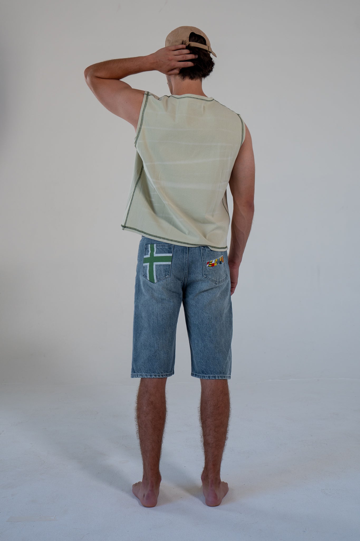leaf finished cutoff tank top with alloy emblem